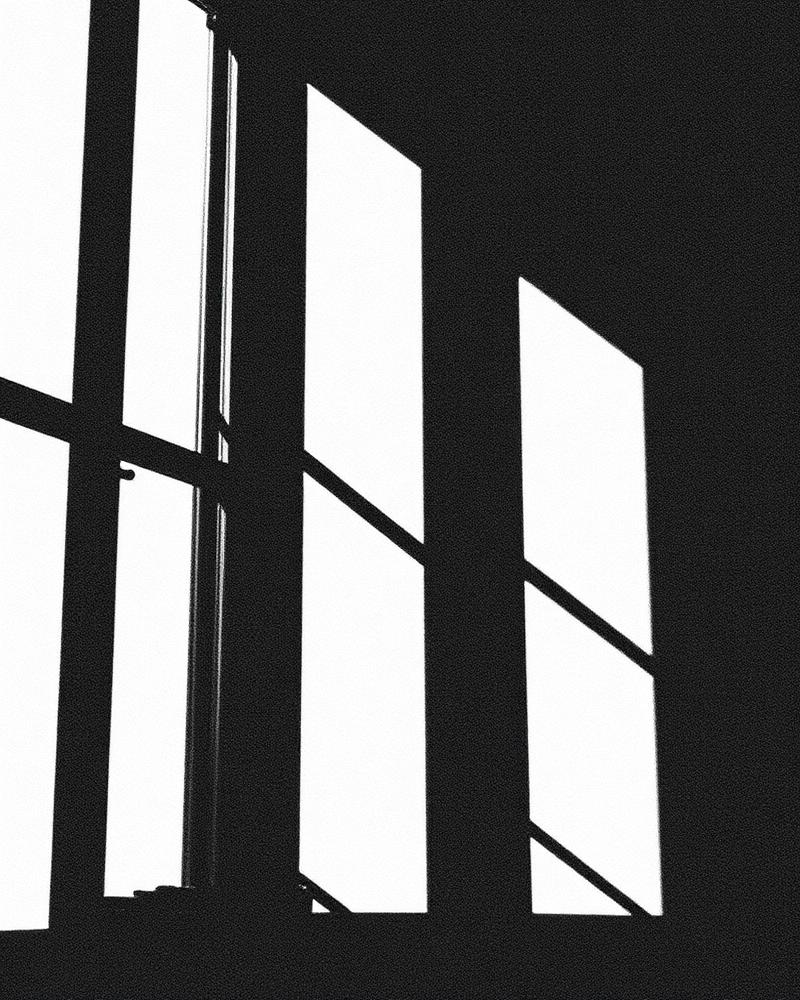 High-contrast black and white study of window light