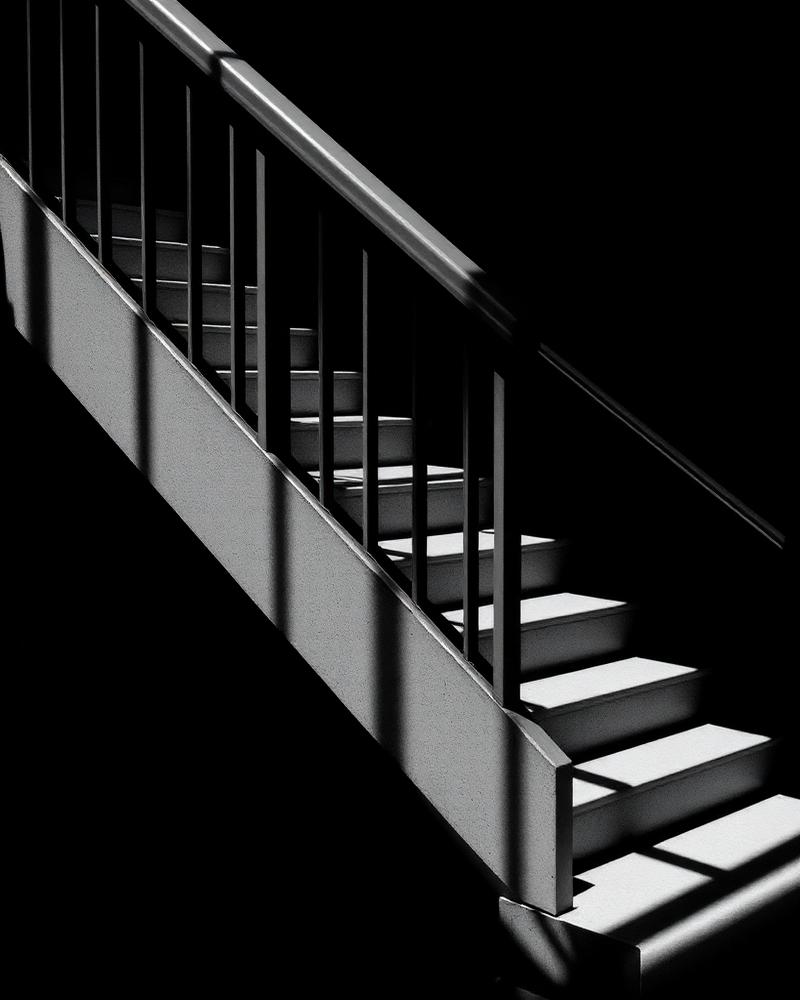 High-contrast black and white study of a concrete staircase